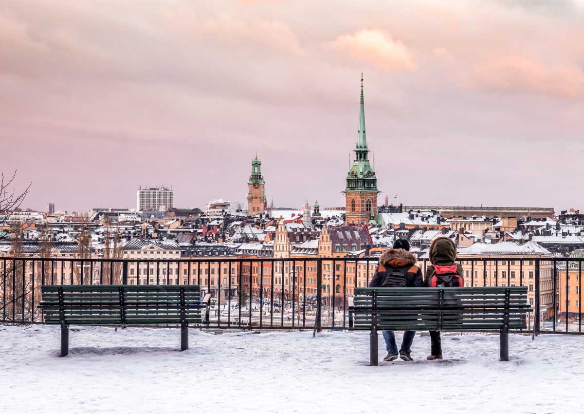 Vintrig utsikt över Gamla stan, med ett par på en bänk i förgrunden