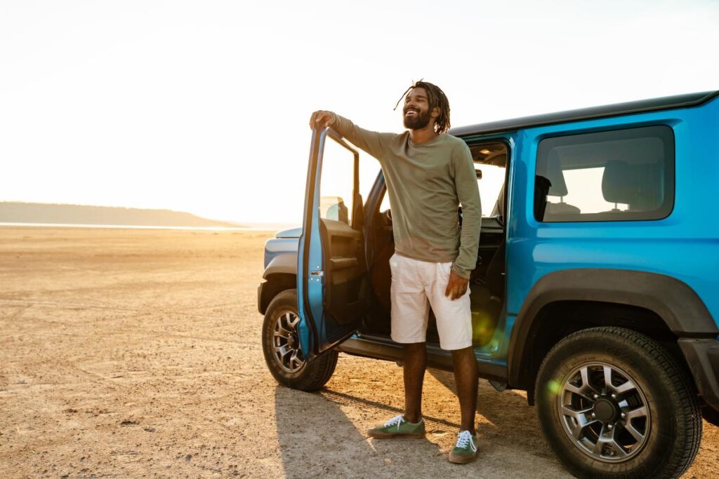 Afrikanska bilmärken: En man och en Jeep i öknen